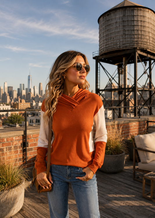 Orange Hoodie modeled by girl on loft rooftop with water tower in background